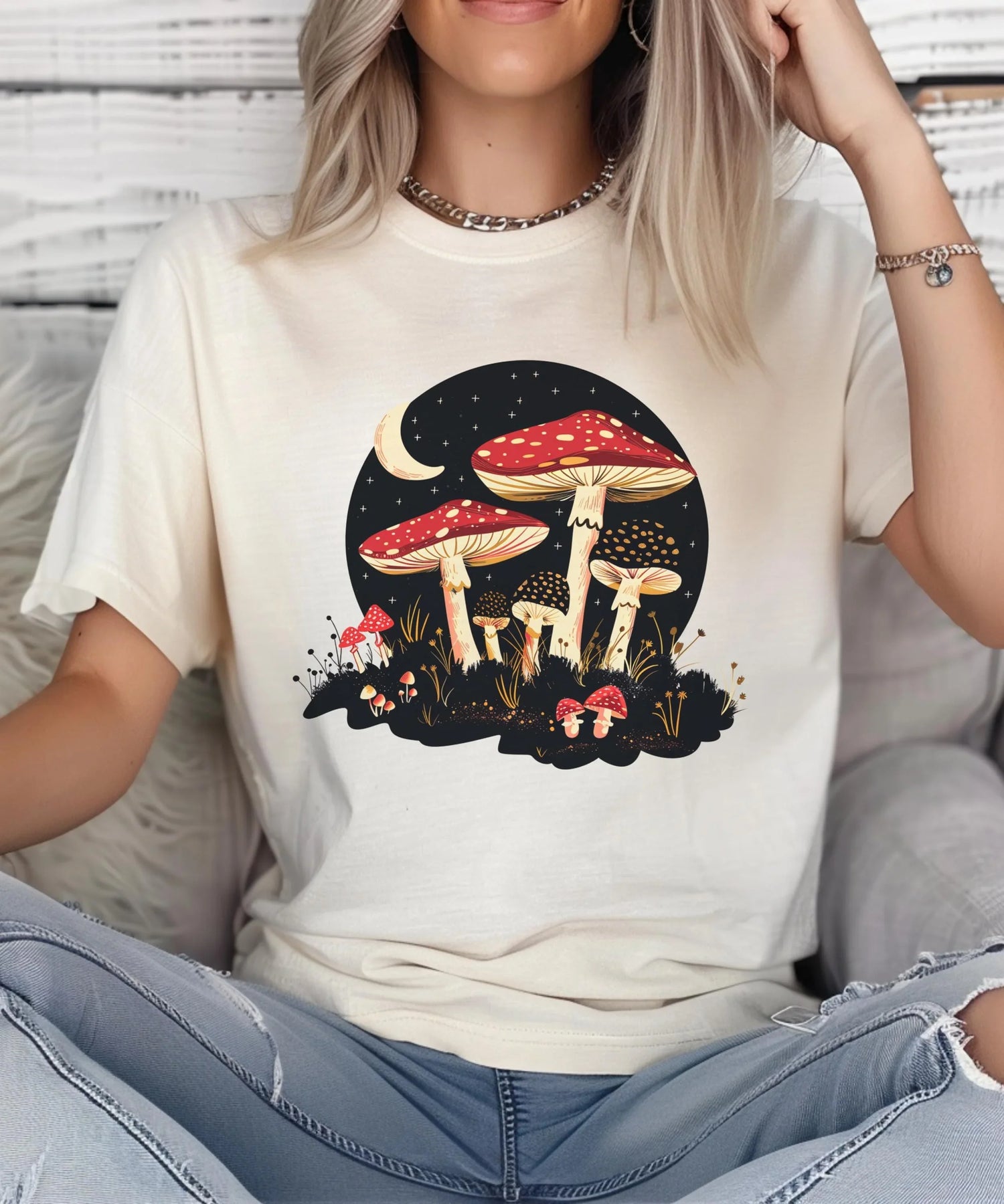 Woman wearing a cream t-shirt with a colorful mushroom illustration against a moonlit night backdrop, showcasing Nature.