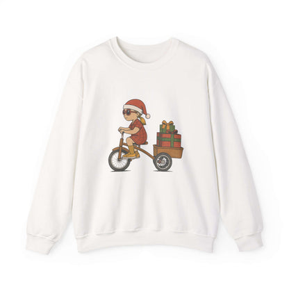 White sweatshirt with a graphic of a child in a Santa hat riding a bike with a cart full of gifts on a white background.